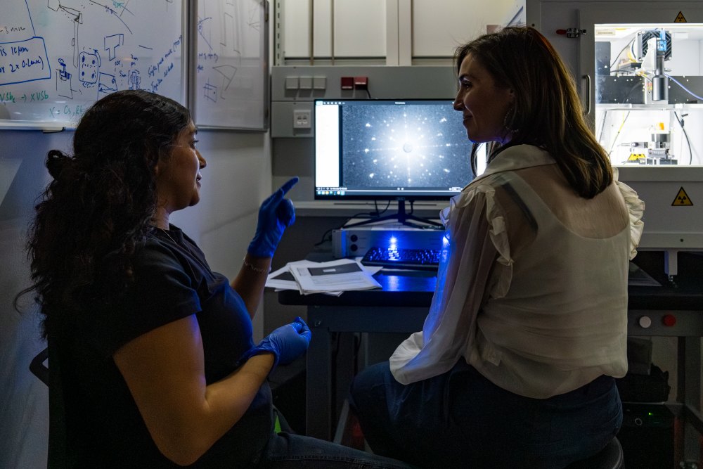 PhD student and first author Valeska Zambra discusses the properties of a UTe2 sample with Assistant Professor Kimberly Modic.